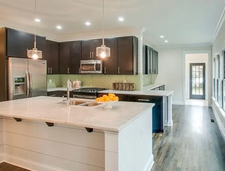 Modern Nashville kitchen with dark painted cabinets and marble countertops