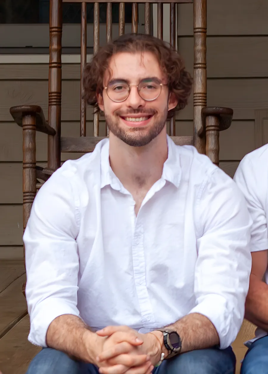 Sawyer Robinson, Alan Robinson's son, smiling on the front porch of the family home
